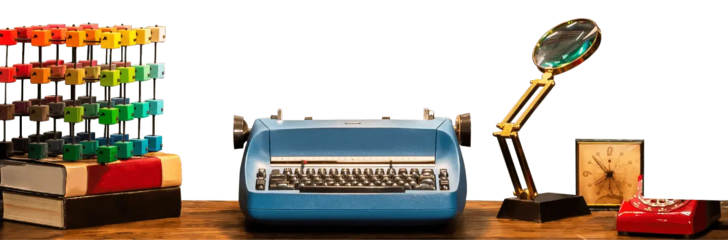 Blue vintage typewriter on a desk with a magnifying glass, and a clock